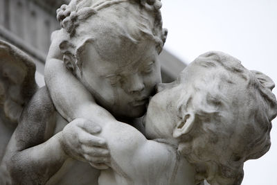 Close-up of female statue against sky