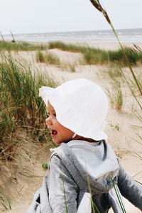 Side view portrait of boy in water at beach