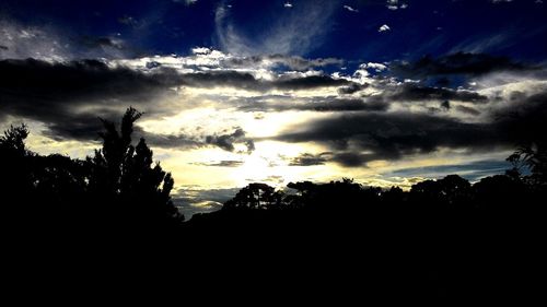 Silhouette of landscape against cloudy sky