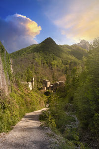 Path leading to the small medieval town of isola santa in garfagnana during sunset