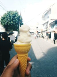 Close-up of hand holding ice cream cone