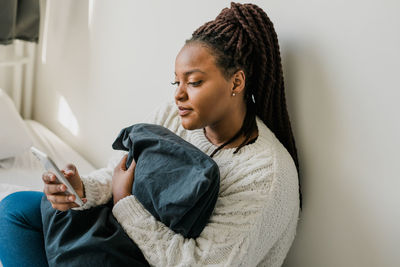 Side view of mother and daughter at home