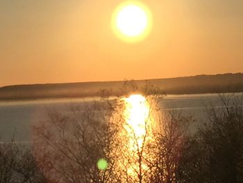Scenic view of sea against orange sky