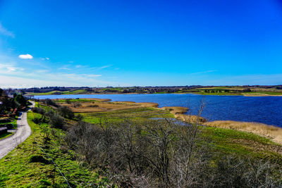 Scenic view of lake against blue sky