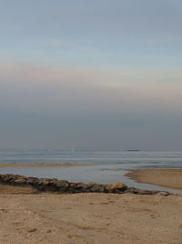 Scenic view of beach against sky during sunset