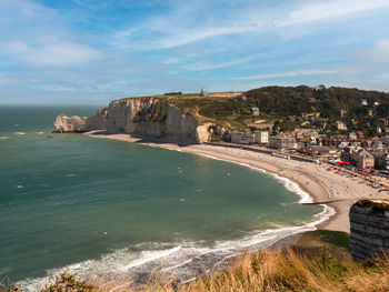 Scenic view of sea and buildings against sky