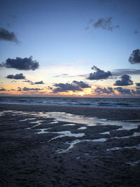 Scenic view of beach against sky during sunset