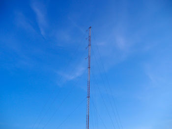 Low angle view of sailboat against blue sky