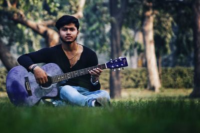 Man playing guitar in park