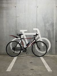 Bicycle parked against wall