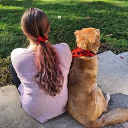 A girl and her dog in matching accessories