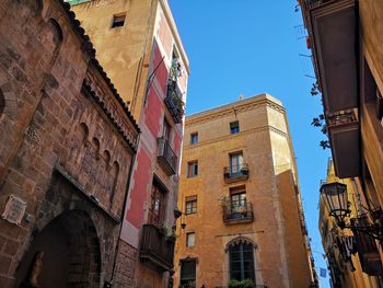 Low angle view of buildings against blue sky