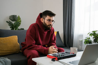 Young man using laptop at home