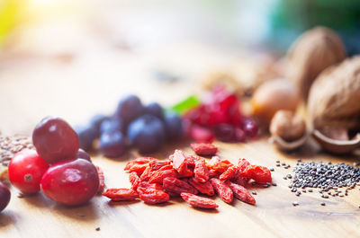 High angle view of fruits and seeds on wooden table