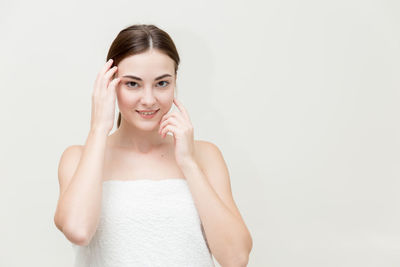 Portrait of a smiling young woman over white background