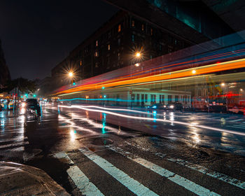 Light trails on city street during rainy season