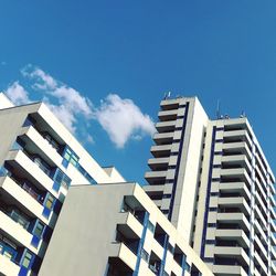 Low angle view of modern buildings against blue sky