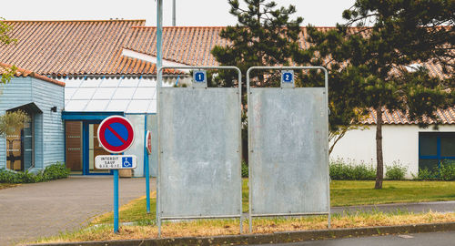 Information sign on road by trees