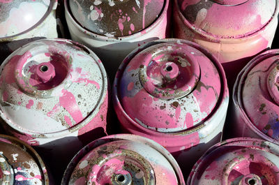 Full frame shot of messy aerosol cans