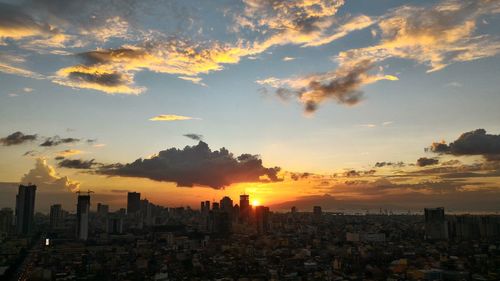 Aerial view of buildings against sky during sunset