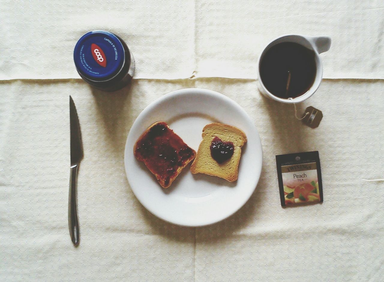 food and drink, food, freshness, indoors, table, drink, still life, coffee cup, coffee - drink, high angle view, plate, refreshment, breakfast, spoon, ready-to-eat, directly above, healthy eating, sweet food, cup, fork