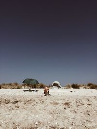 Scenic view of snowy field against clear sky