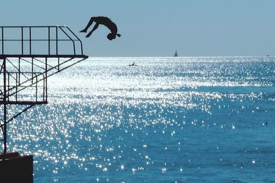 Person jumping in sea