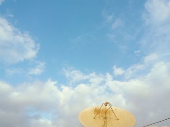 Low angle view of antenna against cloudy sky