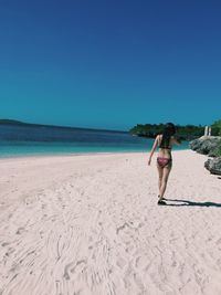 Scenic view of beach against blue sky