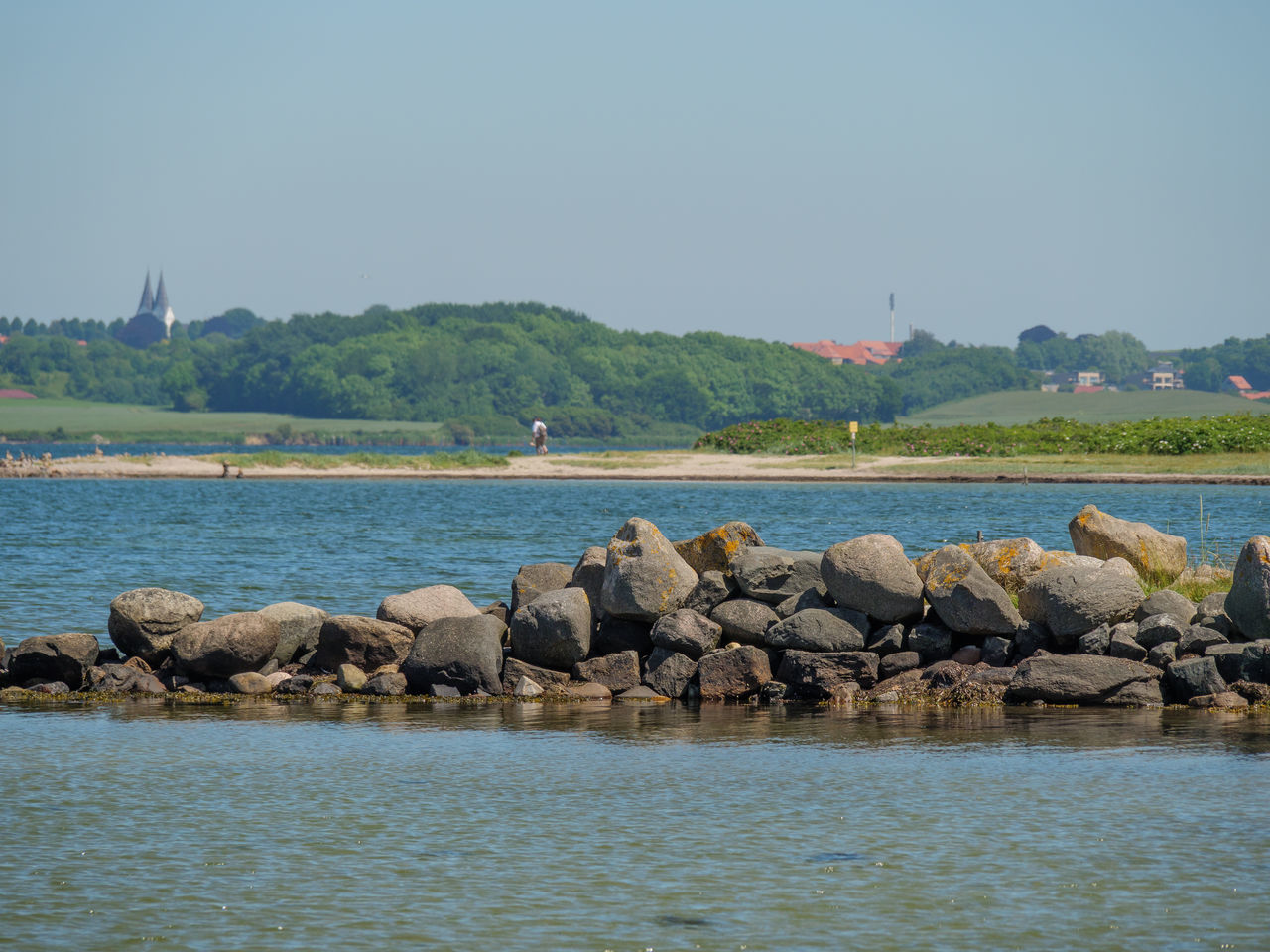 ROCKS IN SEA AGAINST CLEAR SKY