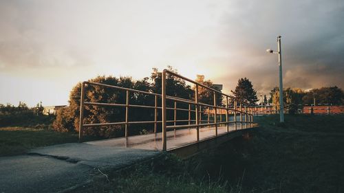 Metallic structure against sky at sunset