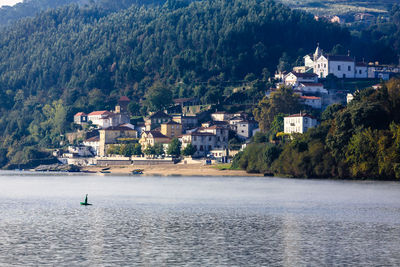 Buildings by douro river against mountain