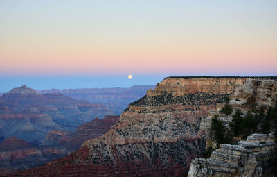 Scenic view of mountains against clear sky during sunset