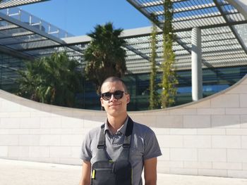 Portrait of man wearing sunglasses standing outdoors