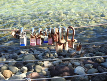 Padlocks hanging on railing