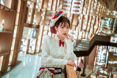 Portrait of young woman standing in store