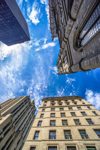 Low angle view of buildings against cloudy sky