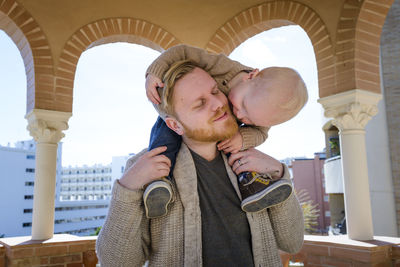 Father and son on his back in a lookout tower on the promenade o