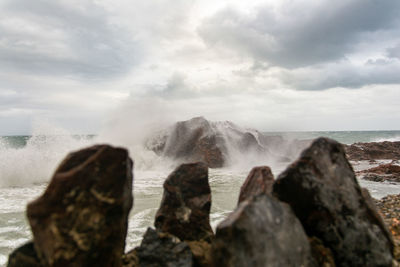 Waves hitting a sea rock with great force. winter storm.