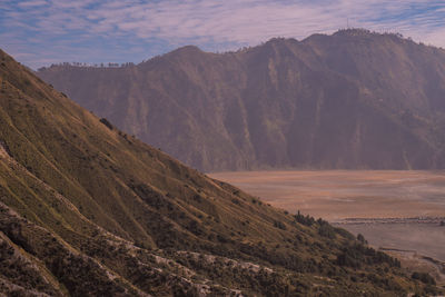 Scenic view of landscape and mountains against sky