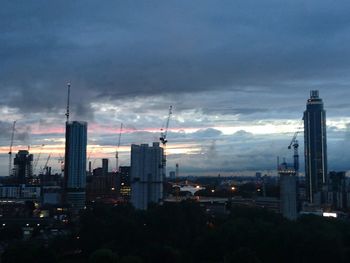 View of cityscape against cloudy sky