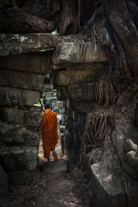 Novice monk in ruined building