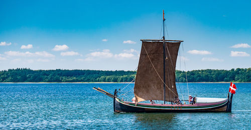 Boat in sea against blue sky