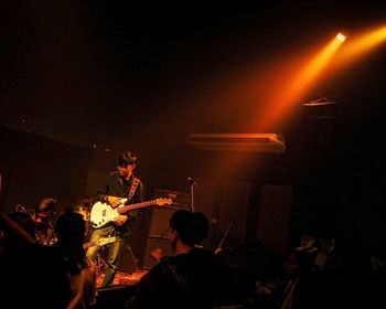 People playing music concert at night