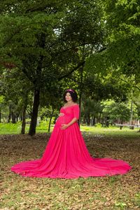 Full length portrait of young woman standing at park