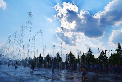 Panoramic view of people against sky