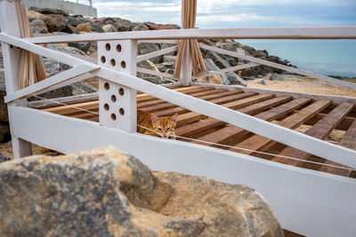 Staircase on beach against sky