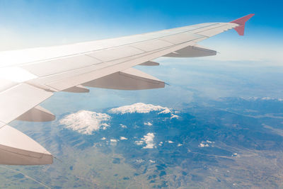 Aerial view of aircraft wing over landscape