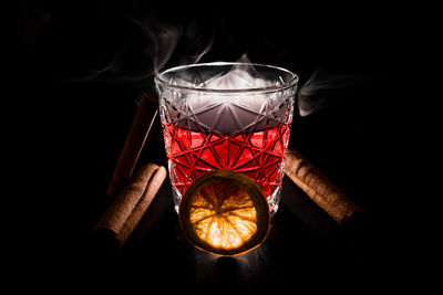 Close-up of illuminated light bulb against black background