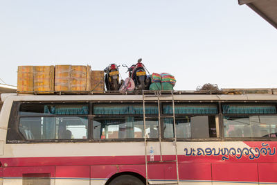 Low angle view of people working against clear sky